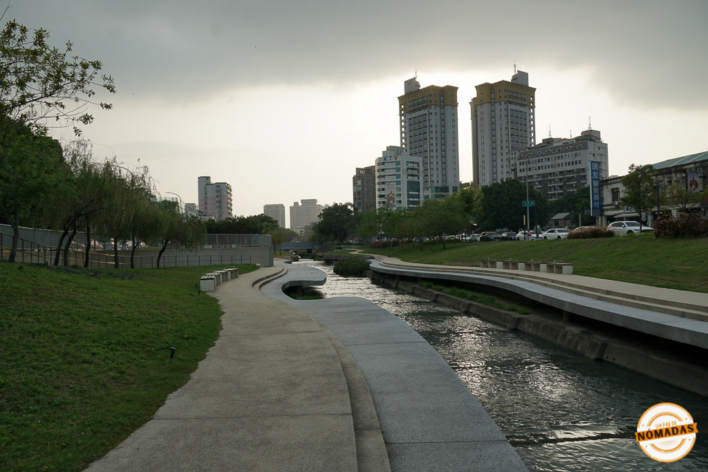 Sendero moderno junto al canal en Maple Garden con rascacielos al fondo