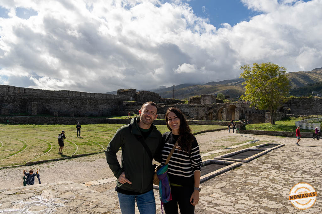 Pareja de viajeros ("Un Par de Nómadas") sonriendo en el patio del Castillo de Gjirokastër.
