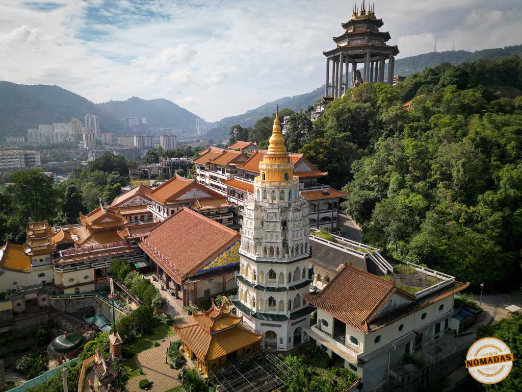 Fotografía aérea panorámica del inmenso complejo budista del templo Kek Lok Si en la ladera de la montaña, mostrando la Pagoda de los Diez Mil Budas y el lejano pabellón de la estatua de Guan Yin en Penang.